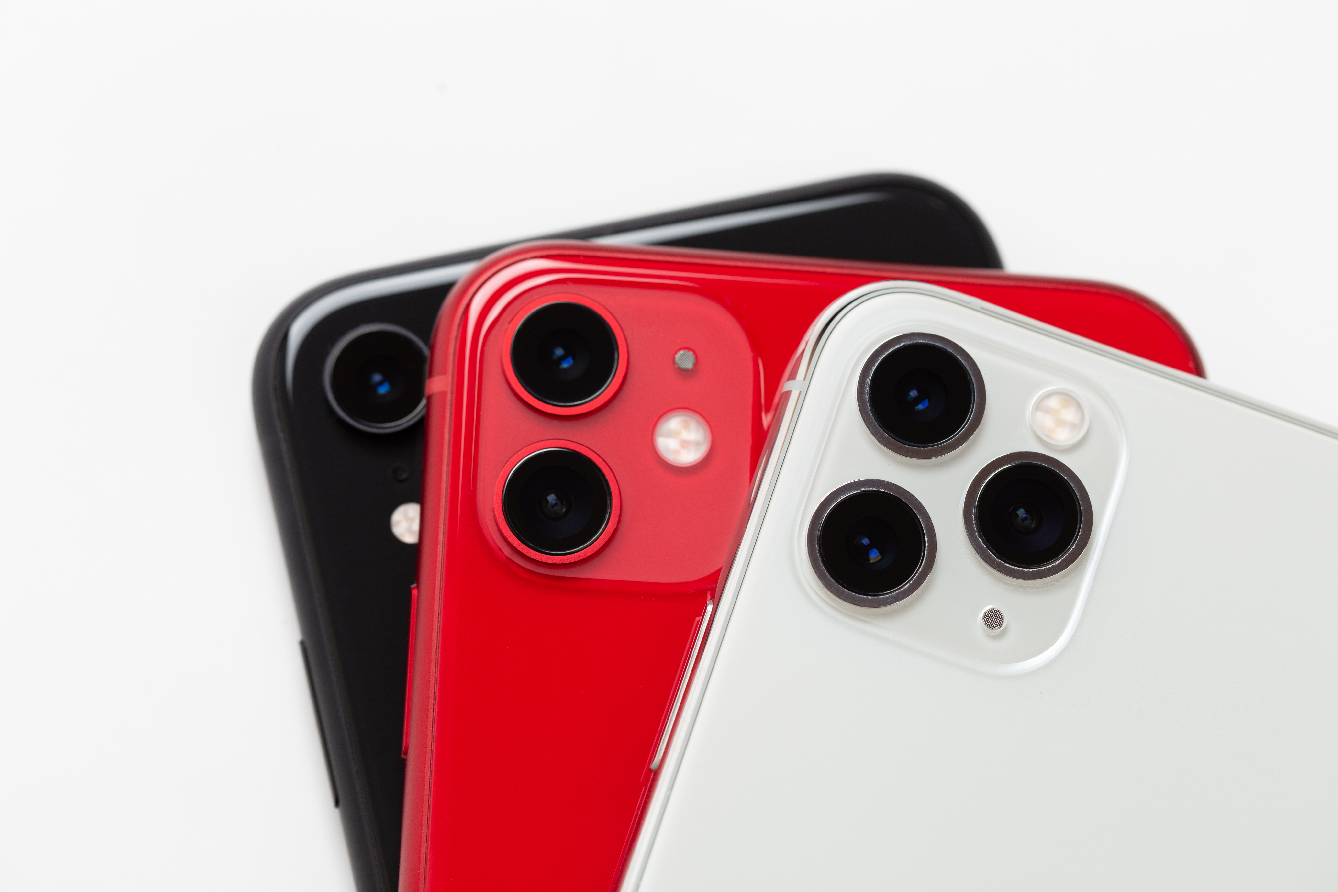 Three smartphones close up on a white background.